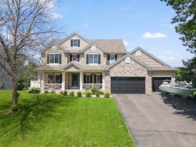 4802 102nd Trl N, Brooklyn Park, MN 55443 - view of front of property with driveway, a porch, a front yard, and a garage