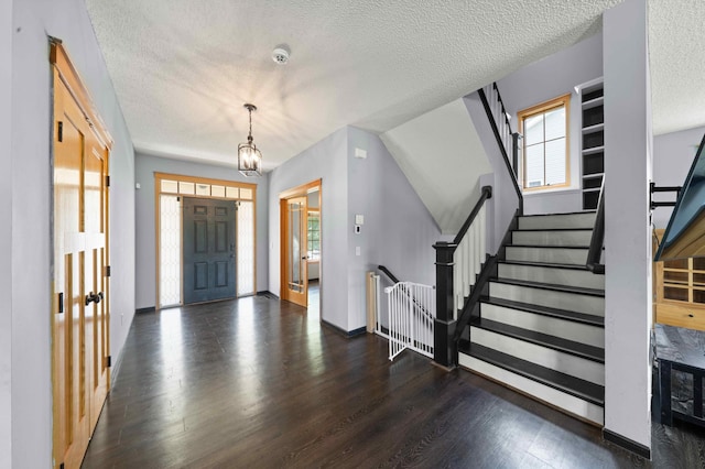 4802 102nd Trl N, Brooklyn Park, MN 55443 - foyer featuring wood finished floors, a textured ceiling, and stairs