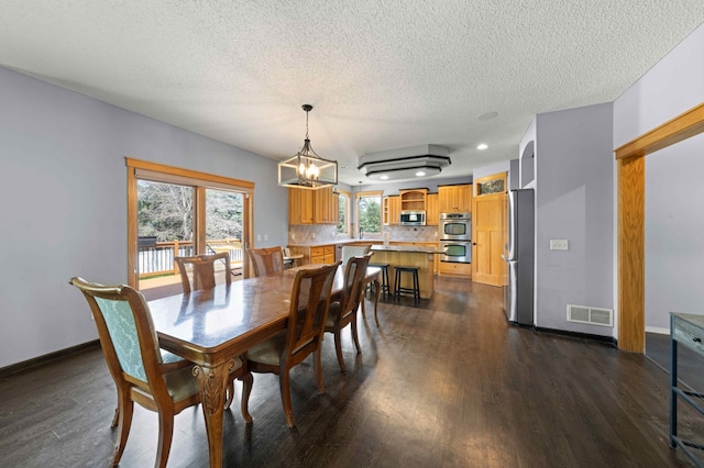 4802 102nd Trl N, Brooklyn Park, MN 55443 - dining space with dark wood-style floors, a chandelier, a textured ceiling, and recessed lighting