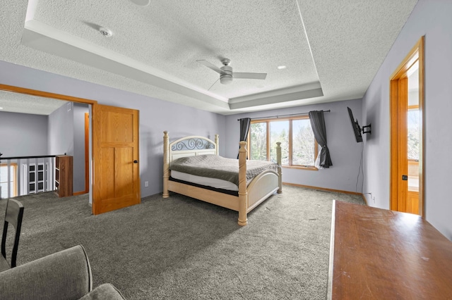 4802 102nd Trl N, Brooklyn Park, MN 55443 - bedroom with a textured ceiling, a tray ceiling, carpet, and ceiling fan