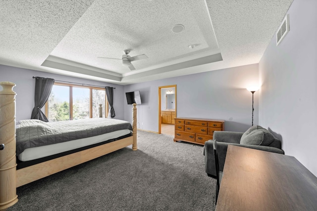 4802 102nd Trl N, Brooklyn Park, MN 55443 - bedroom featuring a textured ceiling, a raised ceiling, carpet floors, ceiling fan, and connected bathroom
