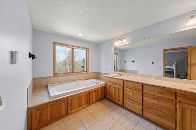 4802 102nd Trl N, Brooklyn Park, MN 55443 - bathroom with a textured ceiling, double vanity, a bath, ensuite bath, and tile patterned floors