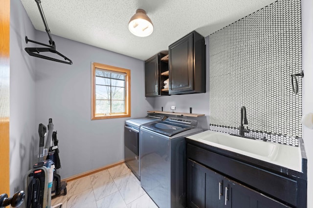 4802 102nd Trl N, Brooklyn Park, MN 55443 - washroom with cabinet space, washer and clothes dryer, light marble finish flooring, and a textured ceiling