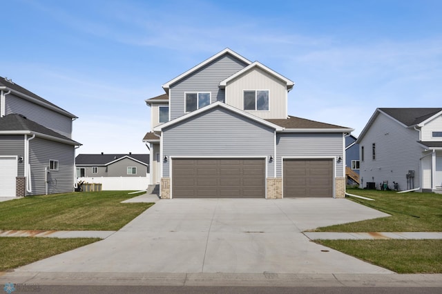 7326 28th St S, Fargo, ND 58104 - view of front of property with board and batten siding, driveway, a front yard, an attached garage, and brick siding