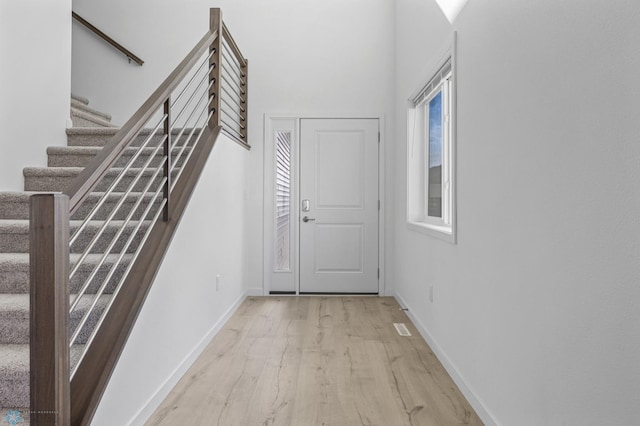 7326 28th St S, Fargo, ND 58104 - hall with light wood-style floors and stairway