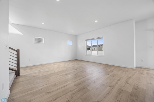 7326 28th St S, Fargo, ND 58104 - unfurnished room featuring light wood-style flooring, stairs, and recessed lighting