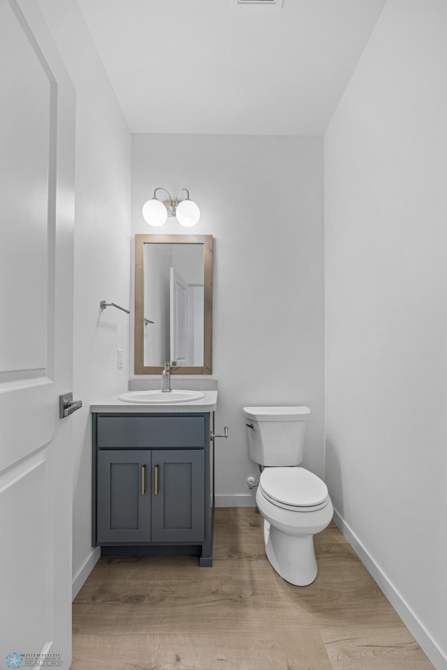 7326 28th St S, Fargo, ND 58104 - half bath with vanity and wood finished floors
