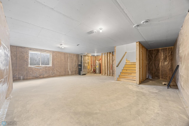 7326 28th St S, Fargo, ND 58104 - below grade area with water heater, heating unit, and stairway