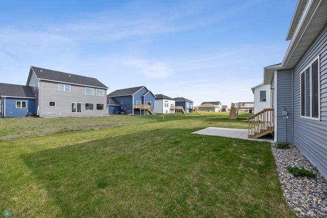 7326 28th St S, Fargo, ND 58104 - view of green lawn featuring a residential view and a patio area