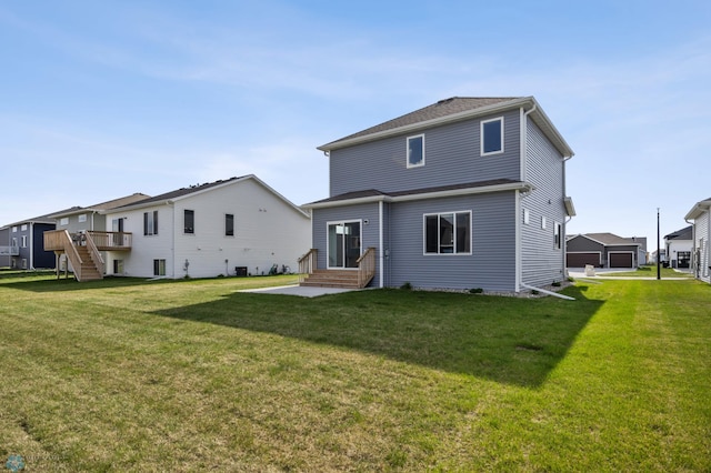 7326 28th St S, Fargo, ND 58104 - rear view of property featuring entry steps, a yard, stairs, and a deck