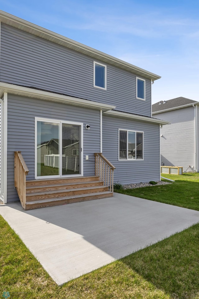 7326 28th St S, Fargo, ND 58104 - back of property featuring a patio and a yard