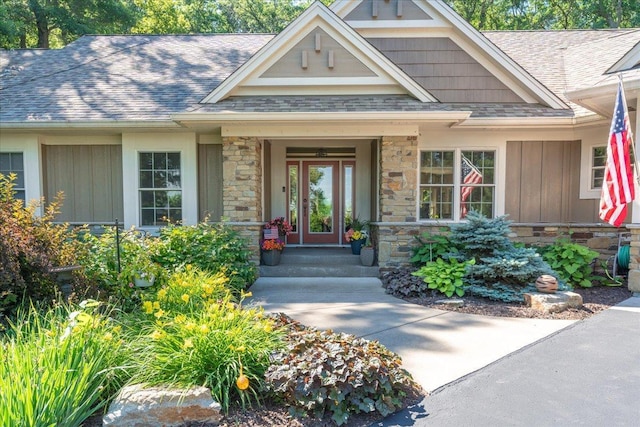 483 Meadow Ridge Ln, Troy Twp, WI 54016 - property entrance featuring board and batten siding, stone siding, a shingled roof, and covered porch