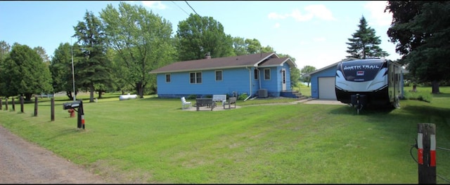 22379 519th Ln, Workman Twp, MN 55760 - rear view of property featuring a garage and a lawn