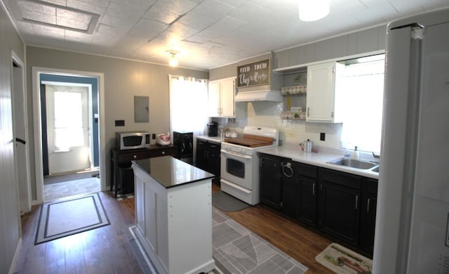 22379 519th Ln, Workman Twp, MN 55760 - kitchen with electric range, open shelves, wood finished floors, a center island, and white cabinetry