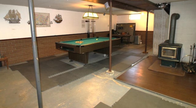 22379 519th Ln, Workman Twp, MN 55760 - recreation room featuring a wood stove, concrete flooring, and billiards