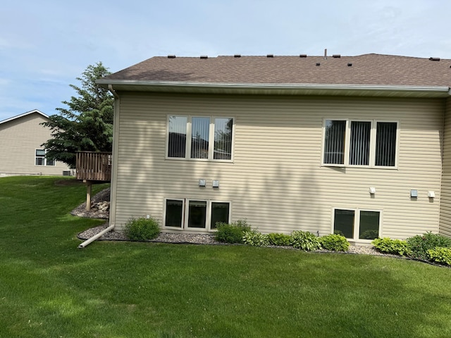 1508 Terrance Cir NE, New Prague, MN 56071 - rear view of property with a yard, a shingled roof, and a deck