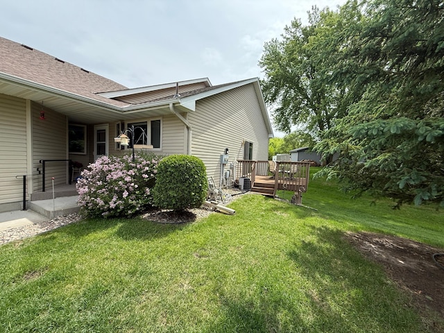 1508 Terrance Cir NE, New Prague, MN 56071 - view of home's exterior featuring a yard, a deck, and roof with shingles