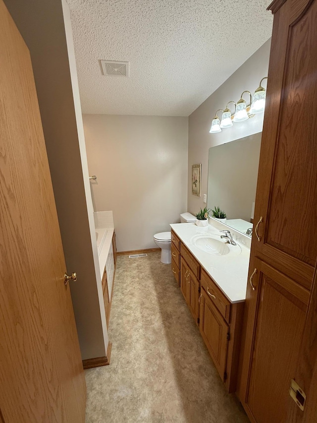 1508 Terrance Cir NE, New Prague, MN 56071 - bathroom with vanity, a tub to relax in, and a textured ceiling