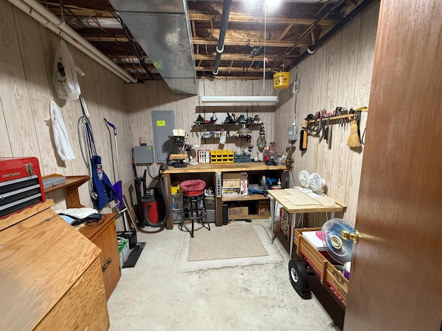 1508 Terrance Cir NE, New Prague, MN 56071 - unfinished basement featuring a workshop area, wood walls, and electric panel