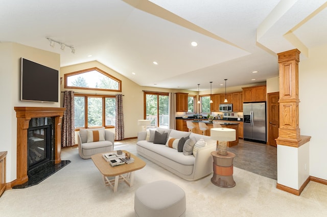 3262 Jade Ct NE, Rochester, MN 55906 - living room with rail lighting, a premium fireplace, lofted ceiling, recessed lighting, and decorative columns