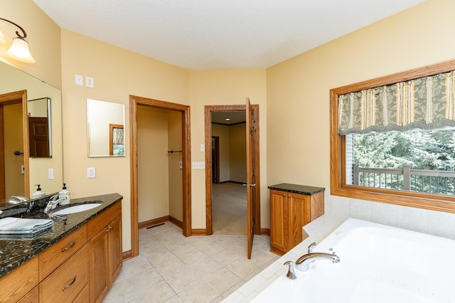 3262 Jade Ct NE, Rochester, MN 55906 - bathroom with vanity, a tub with jets, and tile patterned flooring