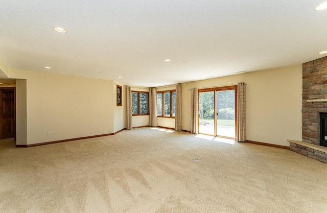 3262 Jade Ct NE, Rochester, MN 55906 - unfurnished living room with light colored carpet, recessed lighting, and a fireplace