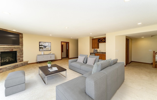 3262 Jade Ct NE, Rochester, MN 55906 - living area featuring light carpet, bar with sink, recessed lighting, and a fireplace