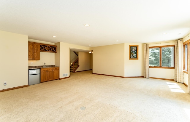 3262 Jade Ct NE, Rochester, MN 55906 - unfurnished living room with wet bar, light colored carpet, stairway, and recessed lighting