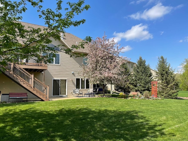 3262 Jade Ct NE, Rochester, MN 55906 - rear view of property with stairway, a yard, a patio area, and a deck