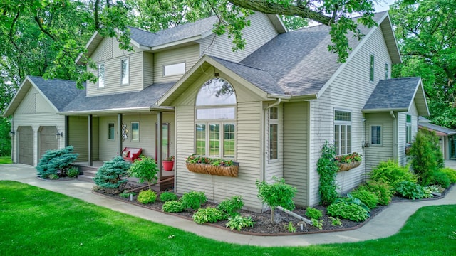 19319 380th St, Erhards Grove Twp, MN 56534 - view of front facade featuring a porch, a shingled roof, a garage, and a front lawn
