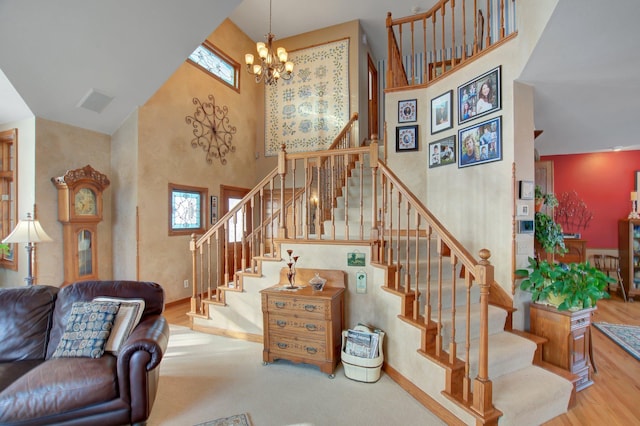19319 380th St, Erhards Grove Twp, MN 56534 - stairs featuring a towering ceiling, a chandelier, and wood finished floors