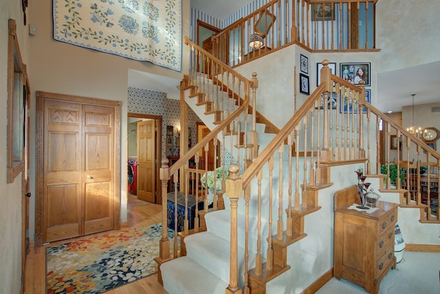 19319 380th St, Erhards Grove Twp, MN 56534 - stairway with a towering ceiling, wood finished floors, and a chandelier