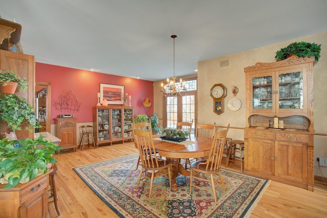 19319 380th St, Erhards Grove Twp, MN 56534 - dining space featuring light wood-style floors and a chandelier