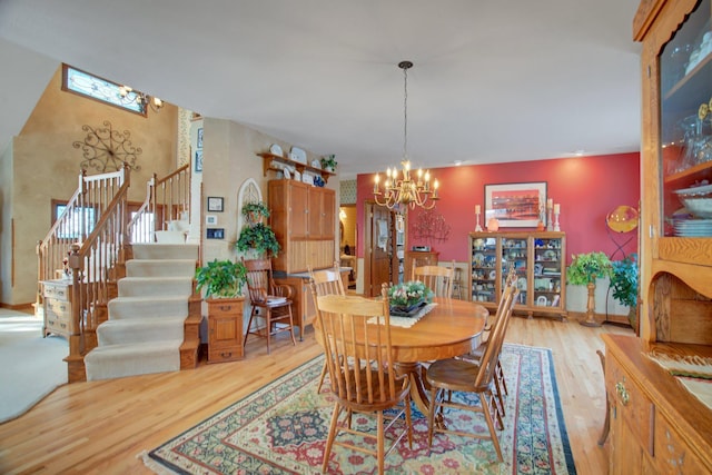 19319 380th St, Erhards Grove Twp, MN 56534 - dining area with wood finished floors, a chandelier, and stairs