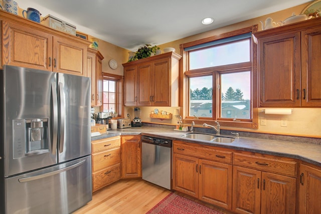 19319 380th St, Erhards Grove Twp, MN 56534 - kitchen with stainless steel appliances, brown cabinetry, light wood-style floors, recessed lighting, and dark countertops