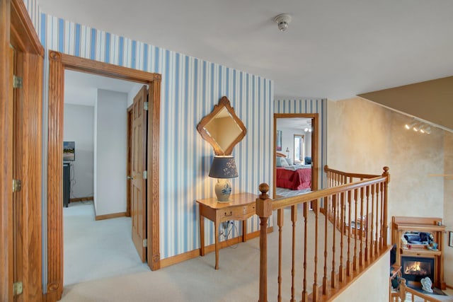 19319 380th St, Erhards Grove Twp, MN 56534 - hallway with an upstairs landing, carpet floors, and wallpapered walls