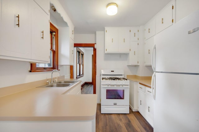 1196 Minnehaha Ave E, Saint Paul, MN 55106 - kitchen featuring white appliances, dark wood-style floors, white cabinetry, light countertops, and a peninsula