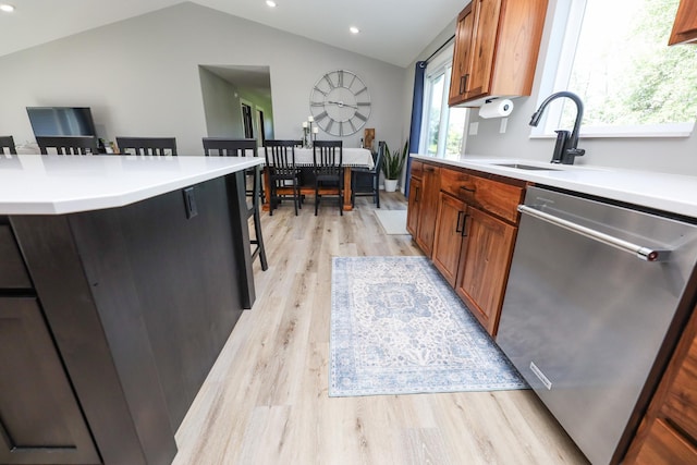 2060 Rosewood Ln SE, Alexandria, MN 56308 - kitchen featuring stainless steel dishwasher, light wood-type flooring, light countertops, vaulted ceiling, and brown cabinets