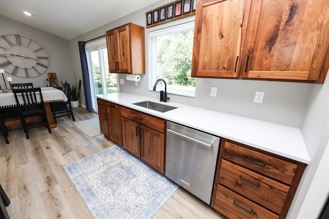 2060 Rosewood Ln SE, Alexandria, MN 56308 - kitchen featuring stainless steel dishwasher, light wood-type flooring, light countertops, brown cabinetry, and recessed lighting
