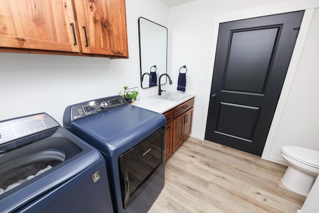 2060 Rosewood Ln SE, Alexandria, MN 56308 - laundry area featuring separate washer and dryer and light wood-type flooring