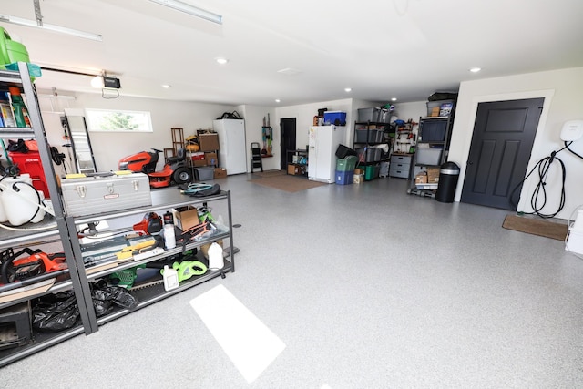 2060 Rosewood Ln SE, Alexandria, MN 56308 - garage with recessed lighting, refrigerator, and white refrigerator with ice dispenser