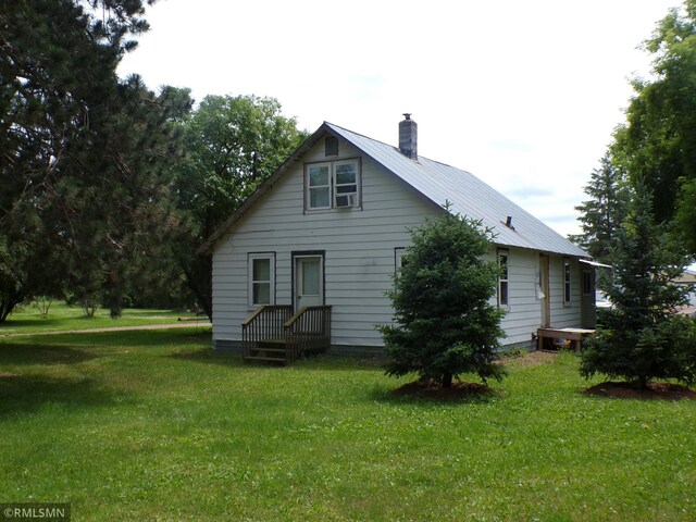 45248 State Highway 48, Clover Twp, MN 55037 - back of property with a chimney, a yard, and cooling unit