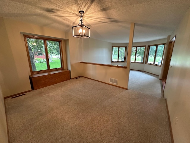1702 15th St SW, Willmar, MN 56201 - unfurnished room with carpet floors, a chandelier, and a textured ceiling