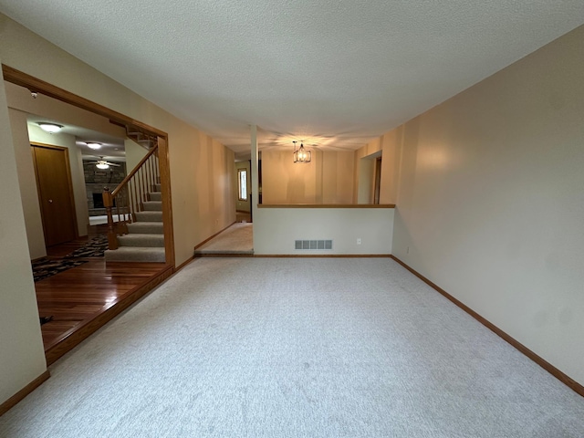 1702 15th St SW, Willmar, MN 56201 - carpeted spare room featuring stairway and a textured ceiling