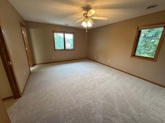 1702 15th St SW, Willmar, MN 56201 - spare room featuring light carpet, ceiling fan, and a textured ceiling