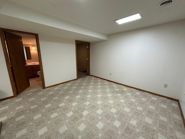 1702 15th St SW, Willmar, MN 56201 - unfurnished bedroom featuring baseboards and connected bathroom