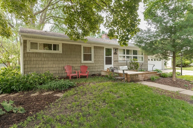 914 11 1/4 St SW, Rochester, MN 55902 - ranch-style home featuring a chimney, an attached garage, a shingled roof, driveway, and a front yard