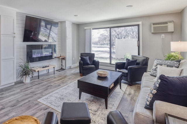 10501 Cedar Lake Rd Unit 217, Minnetonka, MN 55305 - living area with a wall mounted AC and light wood-style flooring