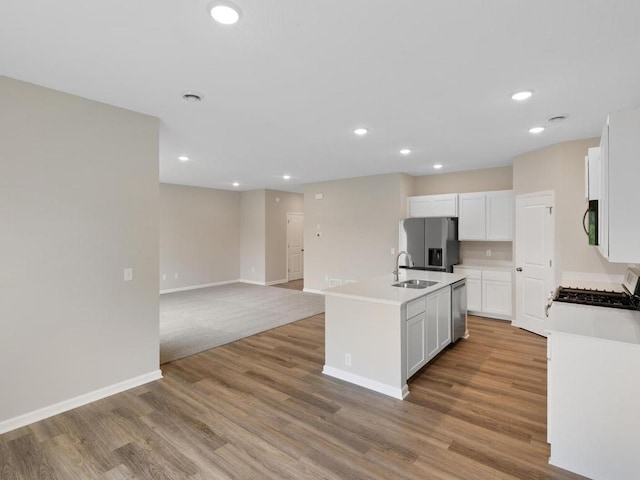 3212 Kady Ave NE, Saint Michael, MN 55376 - kitchen with appliances with stainless steel finishes, a center island with sink, light wood finished floors, white cabinets, and recessed lighting