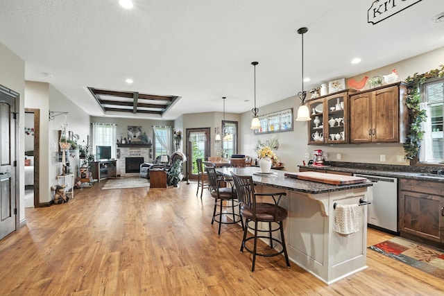 129 Highland Cir, Dassel, MN 55325 - kitchen featuring dishwasher, light wood-type flooring, a breakfast bar area, recessed lighting, and glass insert cabinets